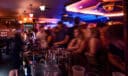 Bartender serving drinks to a large crowd at the Black Rose section of the Heart & Crown