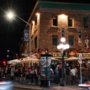 Street view of people enjoying drink on the Heart & Crown patio.