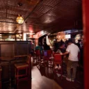 People gathered around the bar at the Snug Pub 