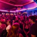 Wide view of a crowd of people dancing at the Black Rose 