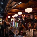 Bartender pouring drinks for guests at the Heart & Crown front room. 